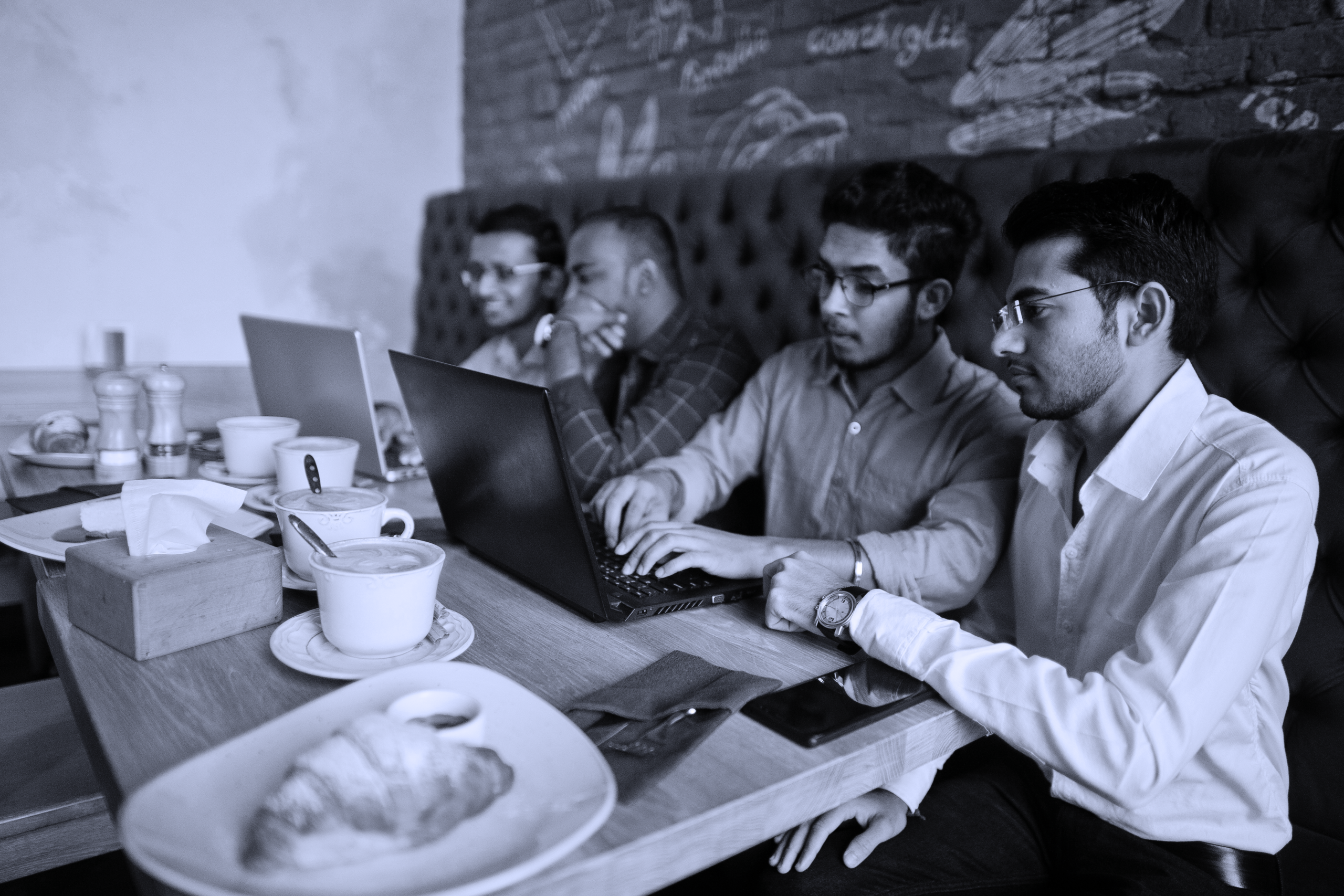 portrait-happy-young-indian-businessman-sitting-cafe