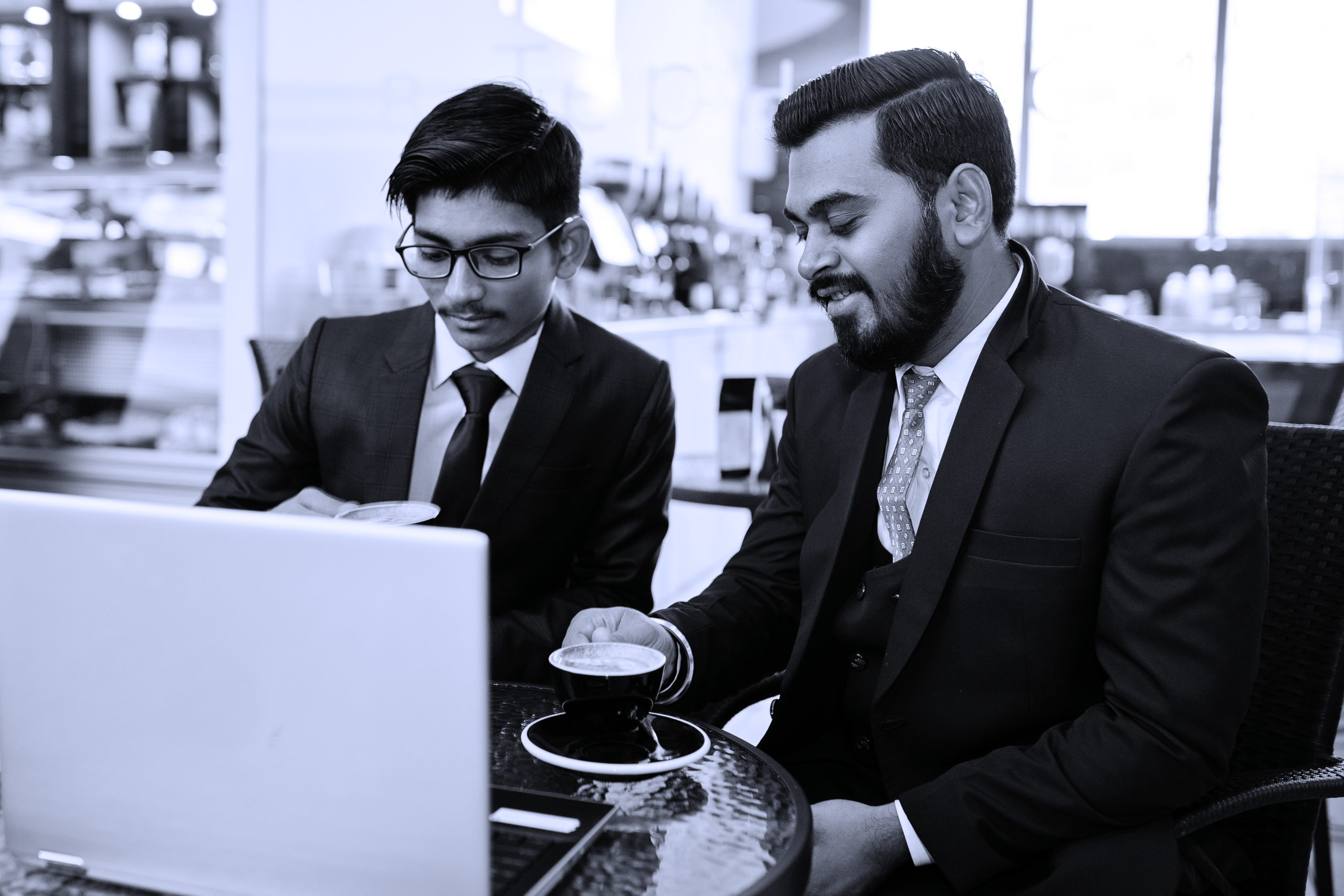 portrait-happy-young-indian-businessman-sitting-cafe